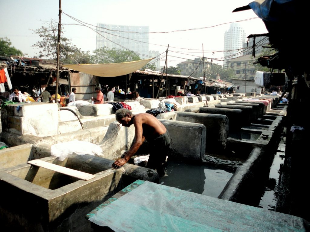 Man washing clothes near Dhobi Ghat